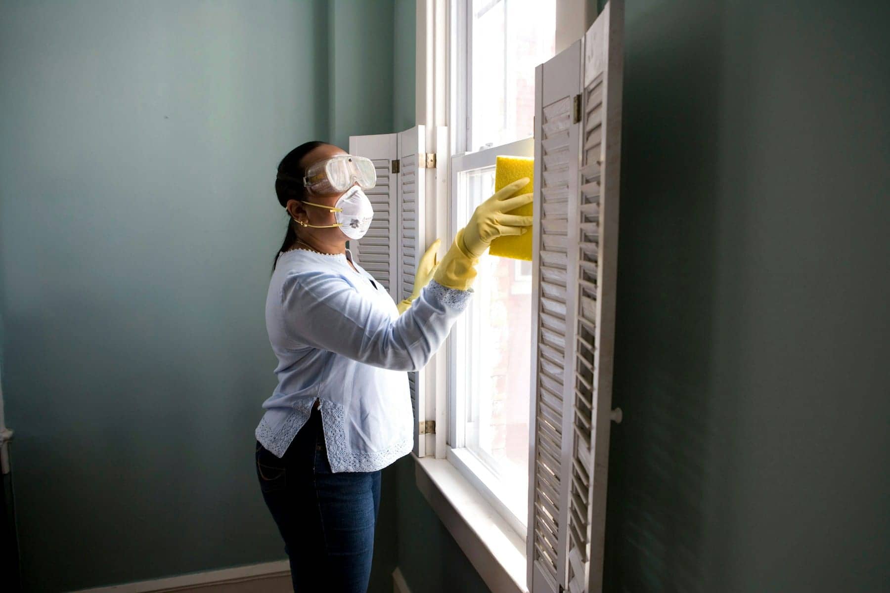 A cleaner working a window to a streak-free finish